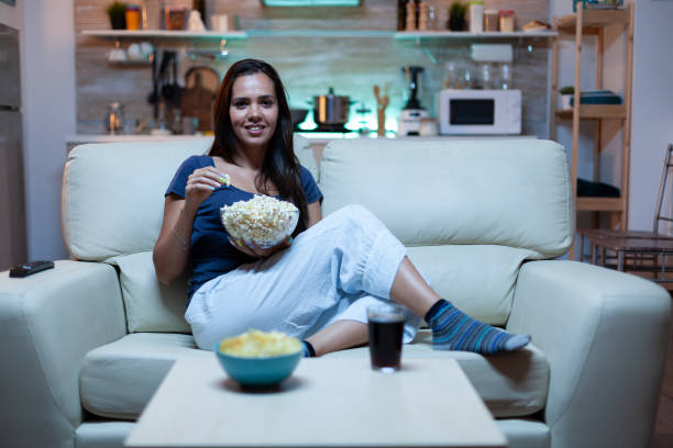 istock Lady resting with snaks watching a movie 1926033087