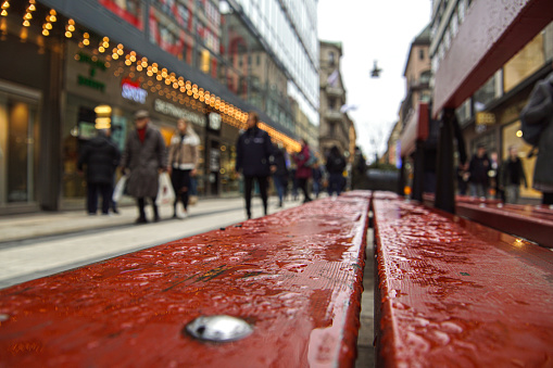 Close up of a street bench during rainy weather