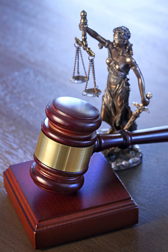 Lady Justice and gavel photographed with a very shallow depth of field.