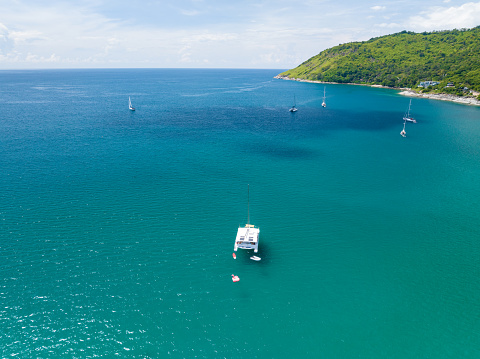 Young couple on anchored sailboat at Olib island, Croatia. View from drone.