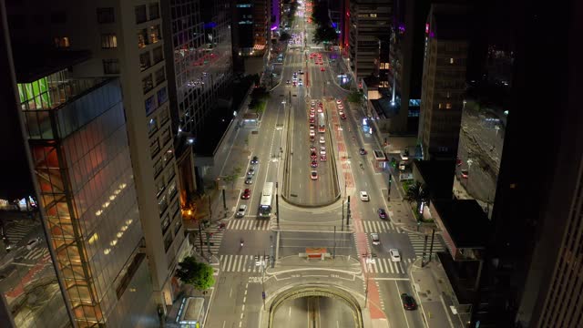 bustling city street intersection at night captured from an aerial perspective