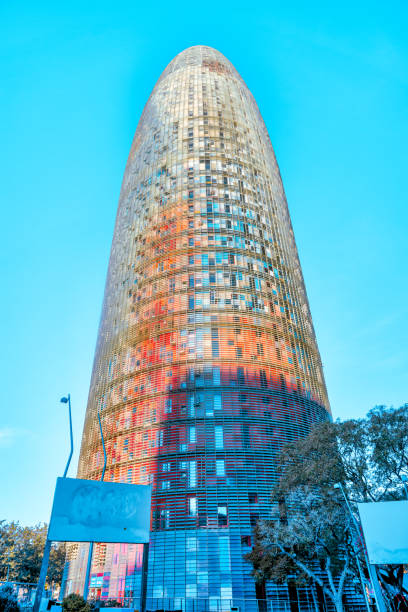 the torre glòries and buildings surrounding it in barcelona spain - arch casa battlo antonio gaudi spain стоковые фото и изображения