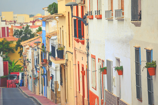 Selective focus on colourful buildings and facades on Denia street in Alicante at Mediterranean spain