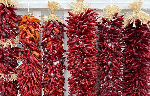 Santa Fe, NM: Row of Chili Ristras Hanging in Snow Full-Frame