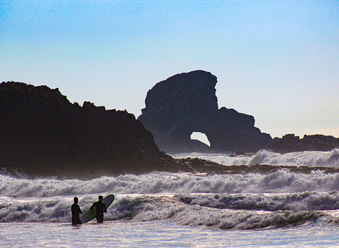 Surfers prepare to take on the waves at Goonies Rock on Indian Creek Beach, Oregon Coast