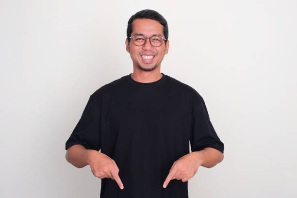istock Adult Asian man smiling happy with both hands pointing below 1926294557
