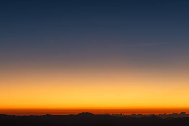 istock Predawn clear sky with orange horizon and blue atmosphere. Smooth orange blue gradient of dawn sky. Heaven at early morning with copy space. Sunset, sunrise backdrop. 1926311735