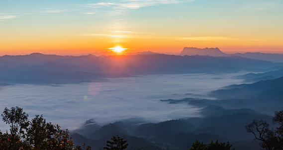 Beautiful Misty Morning with Beautiful Sunrise which clear blue orange sky in morning at doi luang chiang dao, Chiang Mai, Thailand. Panoramic