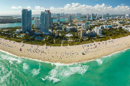 Miami Beach city with high luxury hotels and condos and sandy beachfront. High angle view of tourist infrastructure in southern Florida, USA.