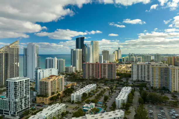 Photo of Expensive highrise hotels and condos on Atlantic ocean shore in Sunny Isles Beach city. American tourism infrastructure in southern Florida