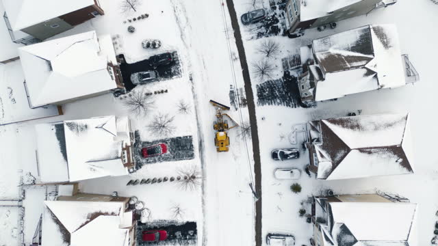 Snowplow Clears Suburban Street