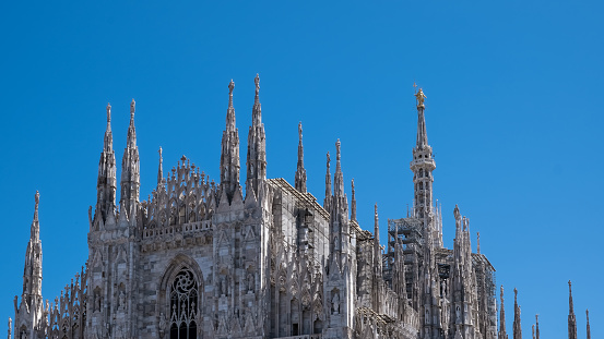 Architectural detail of The Milan Cathedral (Italian, Duomo di Milano), the cathedral church of Milan in Lombardy, Italy. Dedicated to the Nativity of St Mary, it is the seat of the Archbishop of Milan
