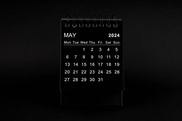 istock Black Calendar for May 2024. Desktop calendar on a black background. 1926432992