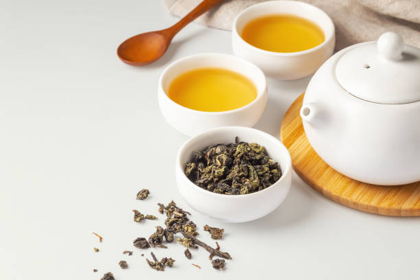 istock Tea set with dried tea leave, cup and teapot on light green background 1926435152