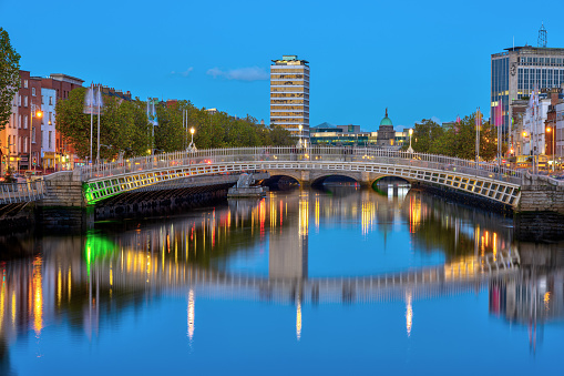 The river Liffey and the famous Ha'penny Bridge in Dublin, Ireland, at twilight