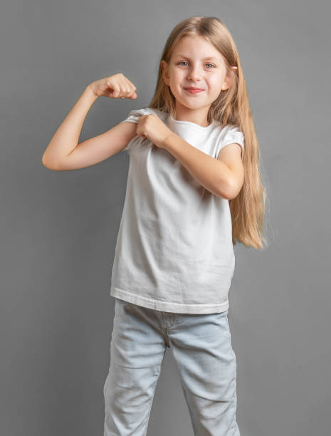 istock A little girl jokingly shows off her biceps. 1926489194