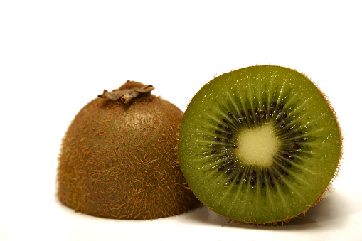 close-up of a fresh kiwi cut in half isolated on white background and copy space