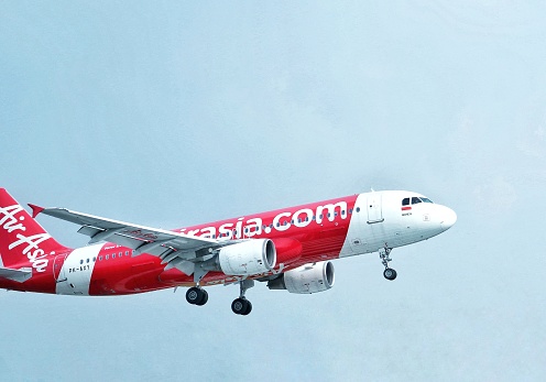 Bandung, Indonesia - June 11, 2021 : Airasia Airbus A320-216 (PK-AXC) landing at Husein Sastranegara international airport in Bandung, Indonesia