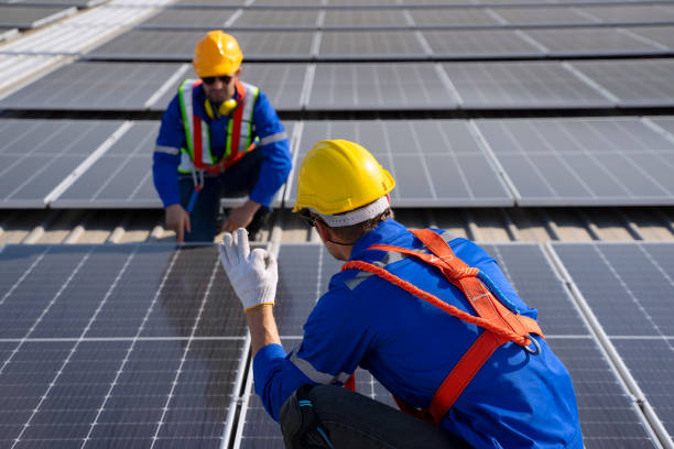 istock Blue collar workers are checking solar panel at roof top. 1926610641