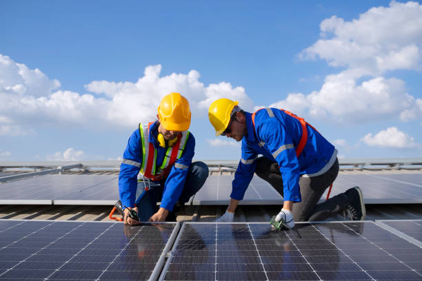 istock Blue collar workers are checking solar panel at roof top. 1926611180