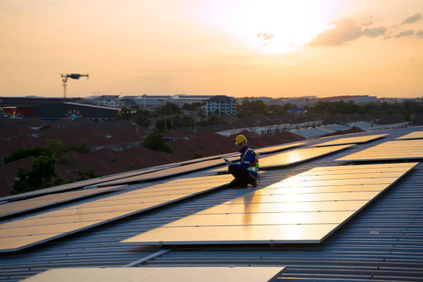 istock Blue collar workers are checking solar panel at roof top. 1926611188
