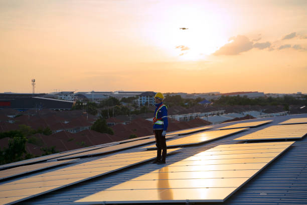 istock Blue collar workers are checking solar panel at roof top. 1926611203