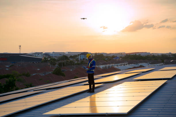 istock Blue collar workers are checking solar panel at roof top. 1926611204