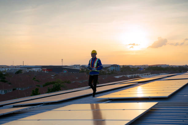 istock Blue collar workers are checking solar panel at roof top. 1926611717
