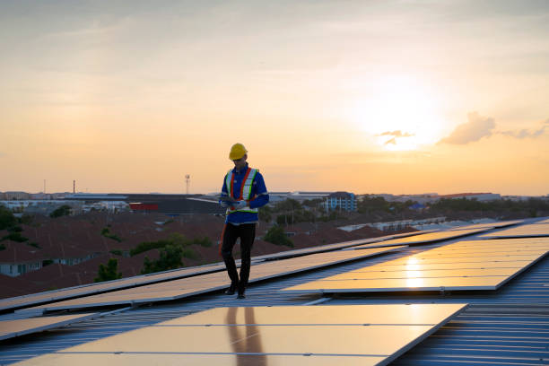 istock Blue collar workers are checking solar panel at roof top. 1926611720