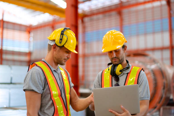 istock Blue collar workers are working at metal warehouse. 1926611812