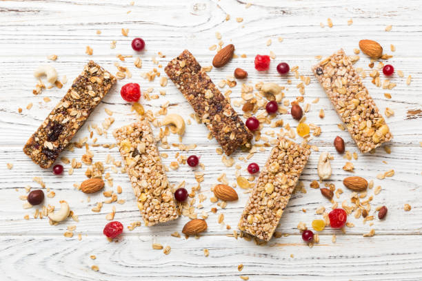 istock Various granola bars on table background. Cereal granola bars. Superfood breakfast bars with oats, nuts and berries, close up. Superfood concept 1926660306