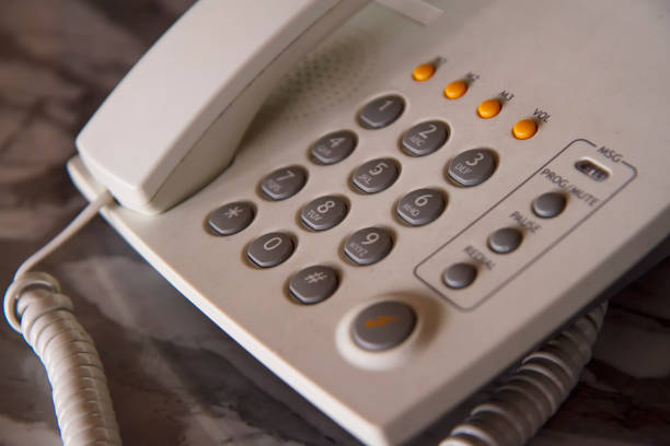 Male hand reaching for a phone receiver