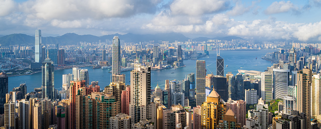 Panoramic view of Hong Kong City  in cloudy day and good weather. View of financial district high-rise and residential buildings from Victoria Peak Observation Deck