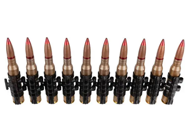 Ammunition belt with cartridges for heavy machine gun isolated on white background.