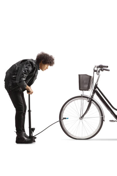istock Young man pumping a flat bicycle tire 1926688860