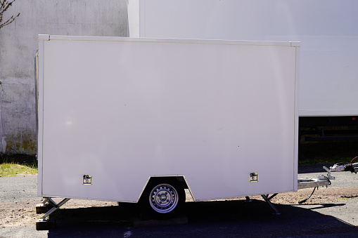 Car trailer with folded awning for a fairground or market stand selling products mobile shop on wheels