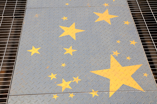 Yellow stars in the checkered plate, closeup of photo