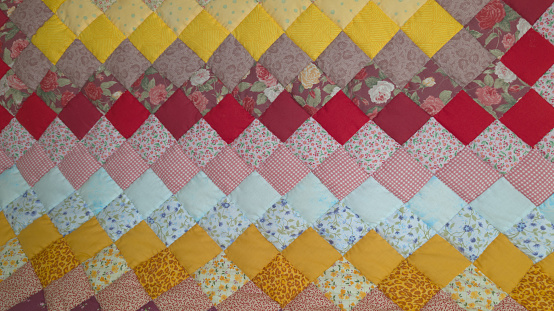 Handmade Patchwork quilt as background Geometrical pattern