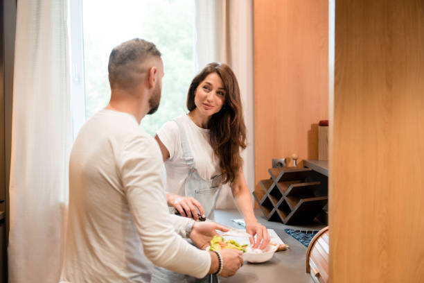 istock Happy family cooking breakfast together on kitchen 1926735749