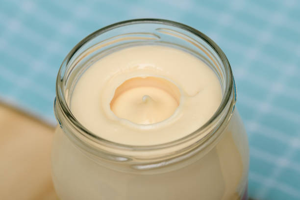 Full, open jar of mayonnaise close-up isolated