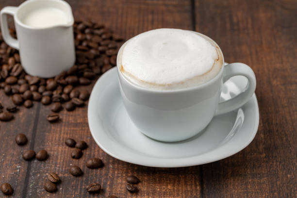 istock Cappuccino coffee in a white porcelain cup on a wooden table 1926766788