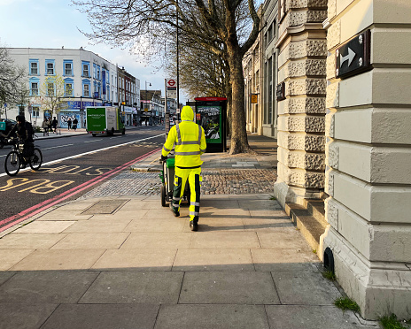 Street cleaner on Stoke Newington High Street in North London. April 2023