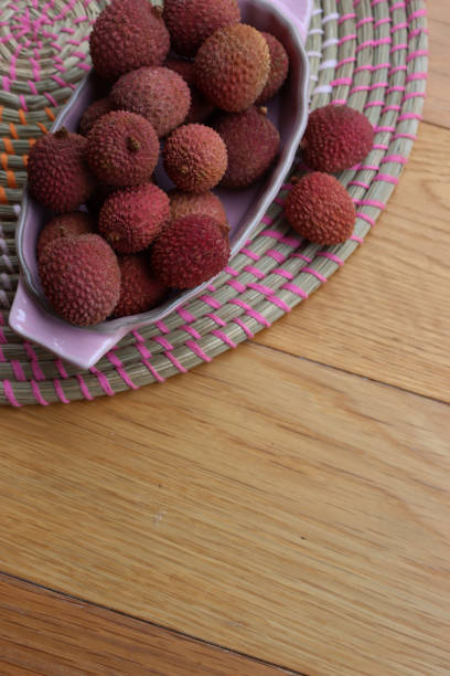 Fresh lychee fruits (Litchi) with leaves isolated on white background
