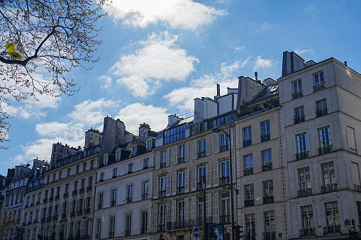 Paris, charming street and buildings, typical parisian facades in the Marais