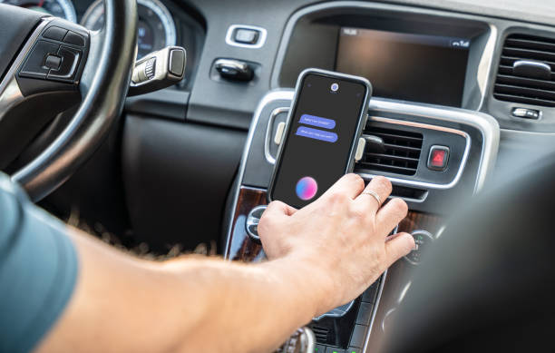 istock Man driving a car and uses chatbot on the smartphone 1926797032