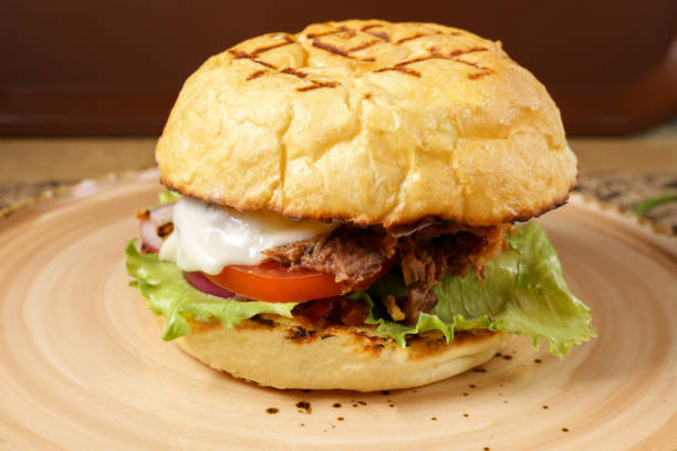 istock Juicy burger with chopped beef, cheese salad and tomato close-up. Selective focus 1926798100