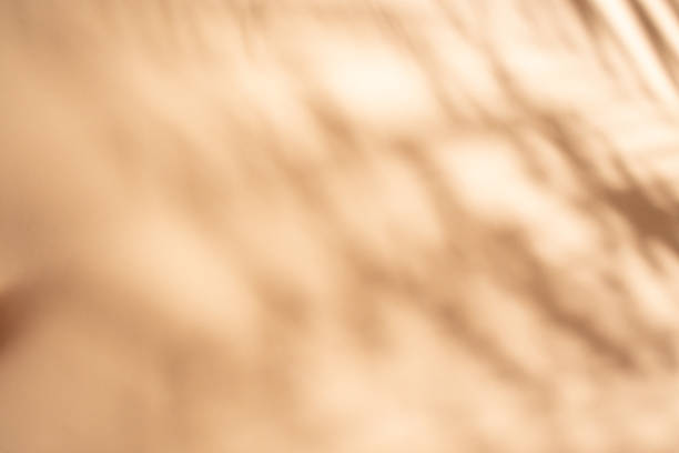 istock Peach cream color backdrop with drapes shadows, abstract defocused photography 1926808648