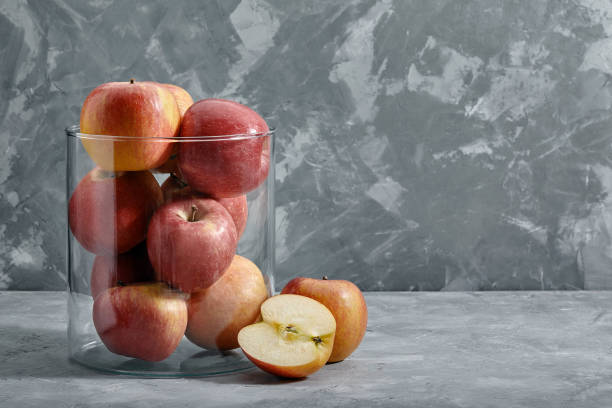 istock Red apples on the table. Top view with copy space on gray stone background. 1926822224