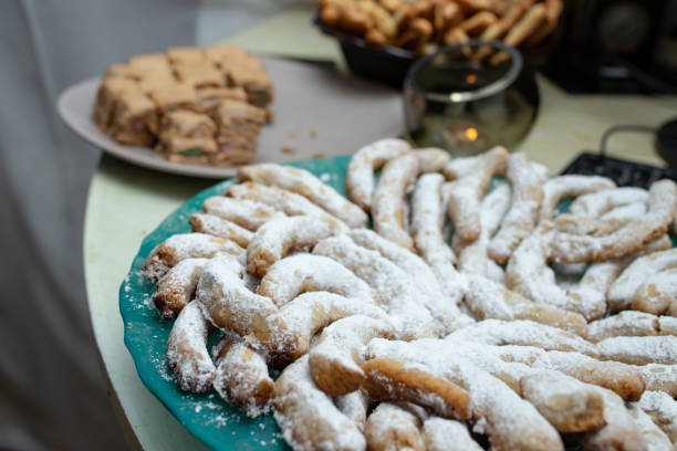 istock Half-moon shaped shortbread cookies sprinkled with powdered sugar, on a green plate,  Soft focus close up 1926822737