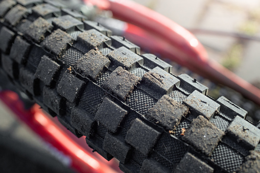 Checkered bicycle tire texture close up, with dust and dirt, soft focus